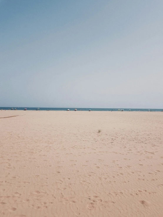 two large sandy beach with several boats on top of it