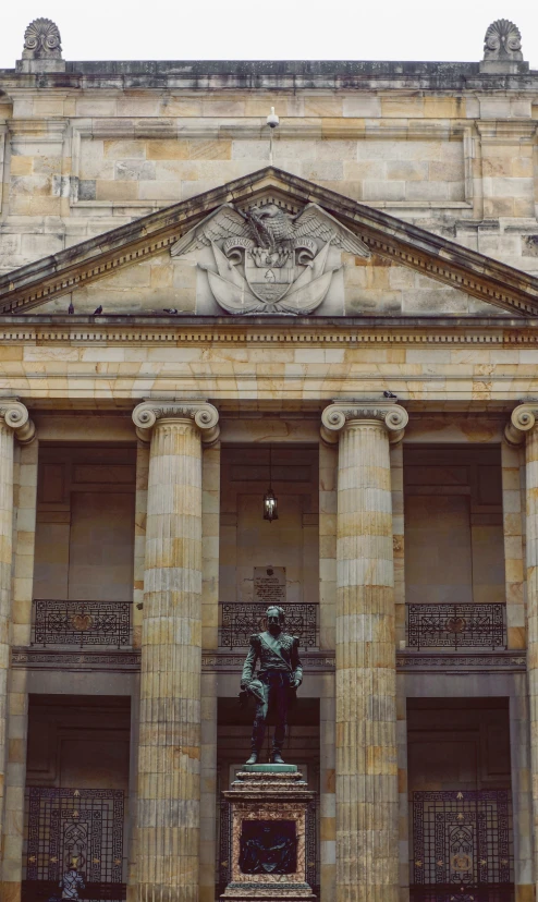 a stone building has pillars with carvings around it