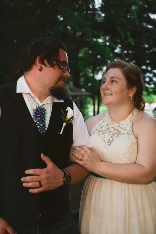 a bride and groom smiling at each other