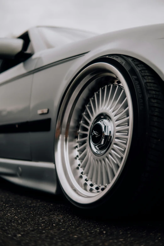 a close up of a silver sports car tire