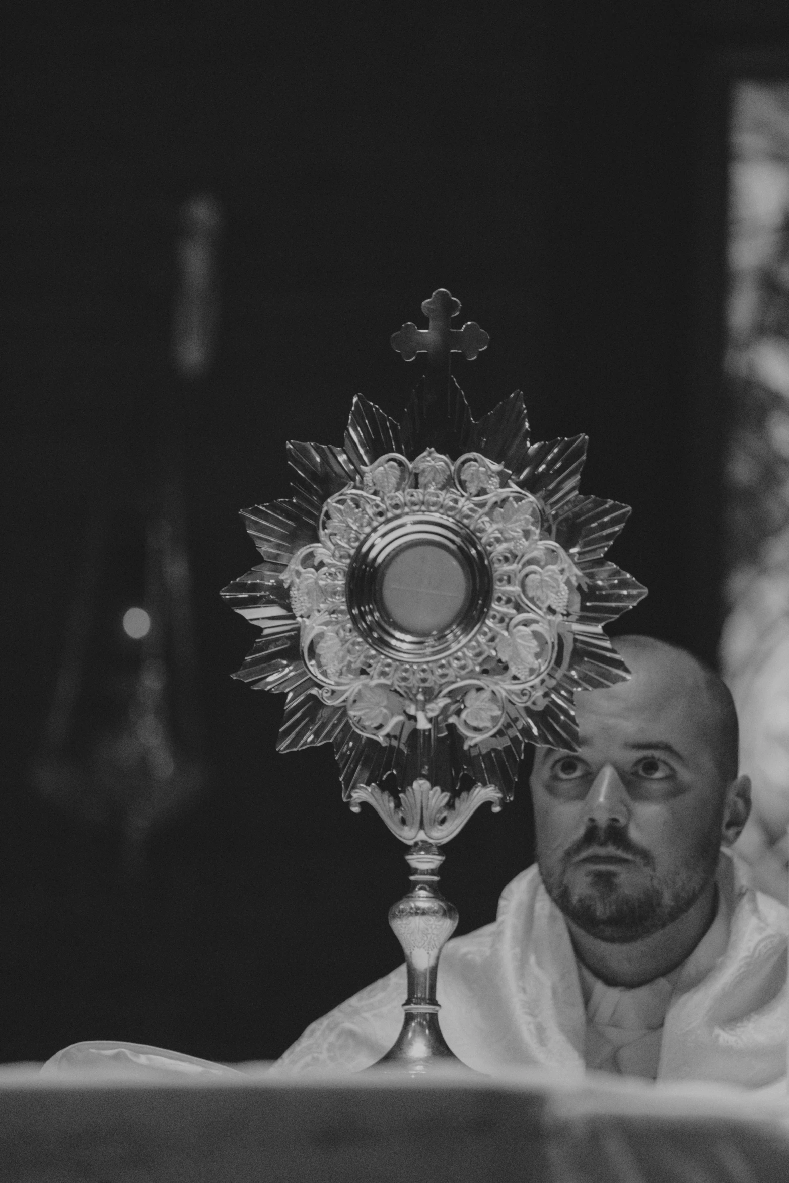 a priest sitting in front of a altar