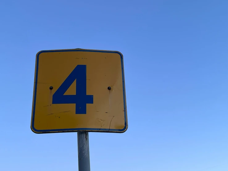 an unopened sign in front of a blue sky