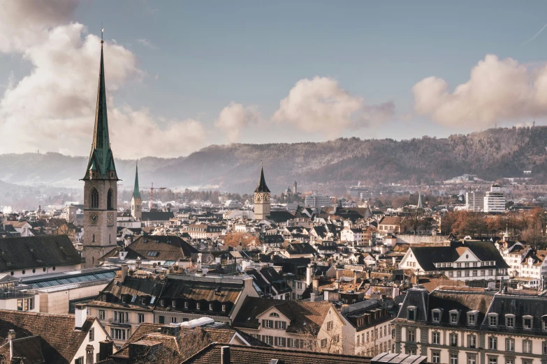 a large city that has a steeple in the background