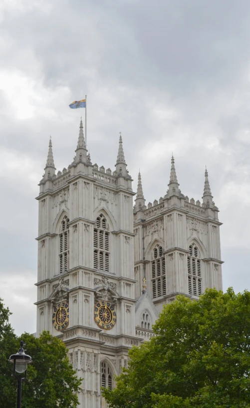 a tall cathedral with an outside clock on top