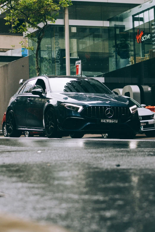 a mercedes with hoods and headlamps parked in the street