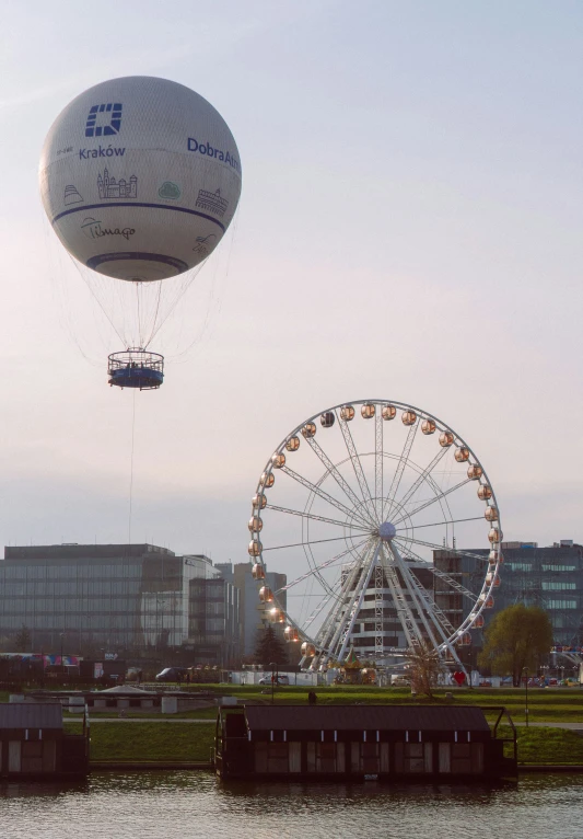 an open air balloon in the sky over water