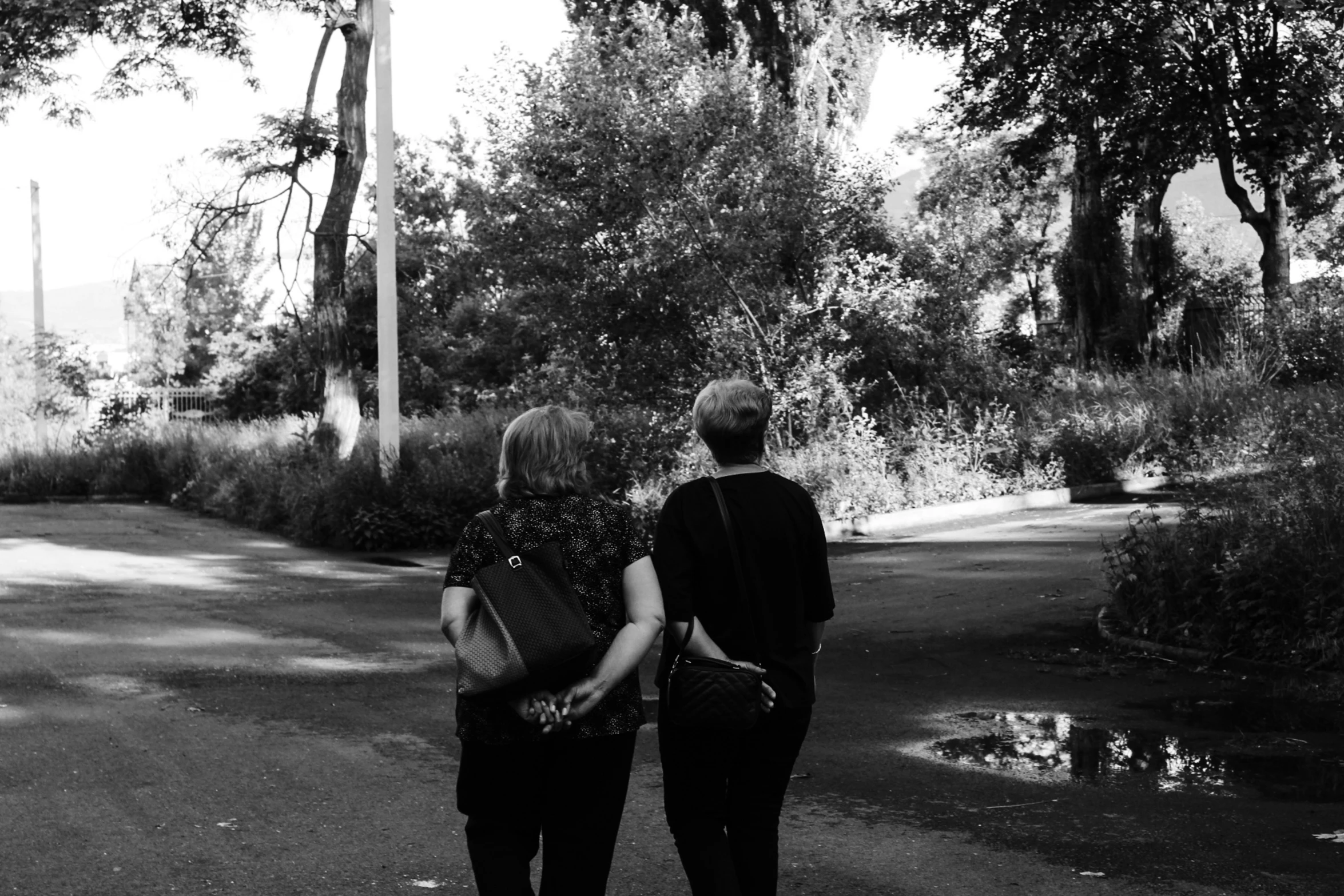 black and white image of two people walking together