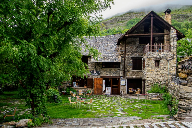 a stone house is surrounded by trees and rocks