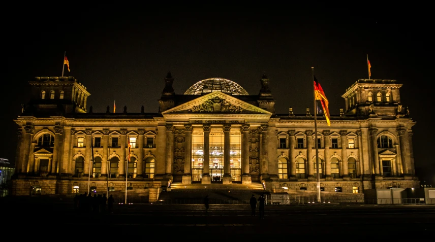 a large white building with two towers lit up