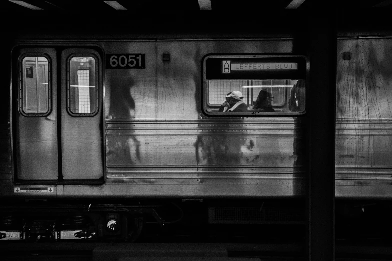 a train with two people standing near it