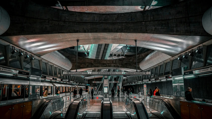 an empty train station with people waiting for their train