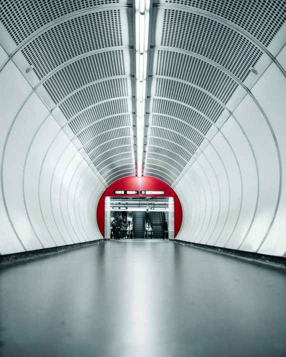 a picture of an empty subway platform with red and white rails