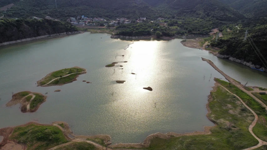 a wide lake with lots of water surrounded by mountains