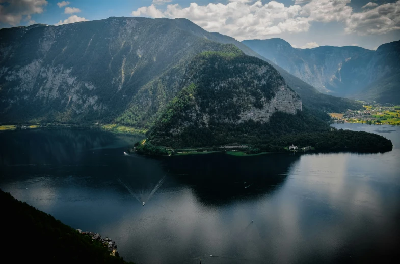 an island is surrounded by mountains and water