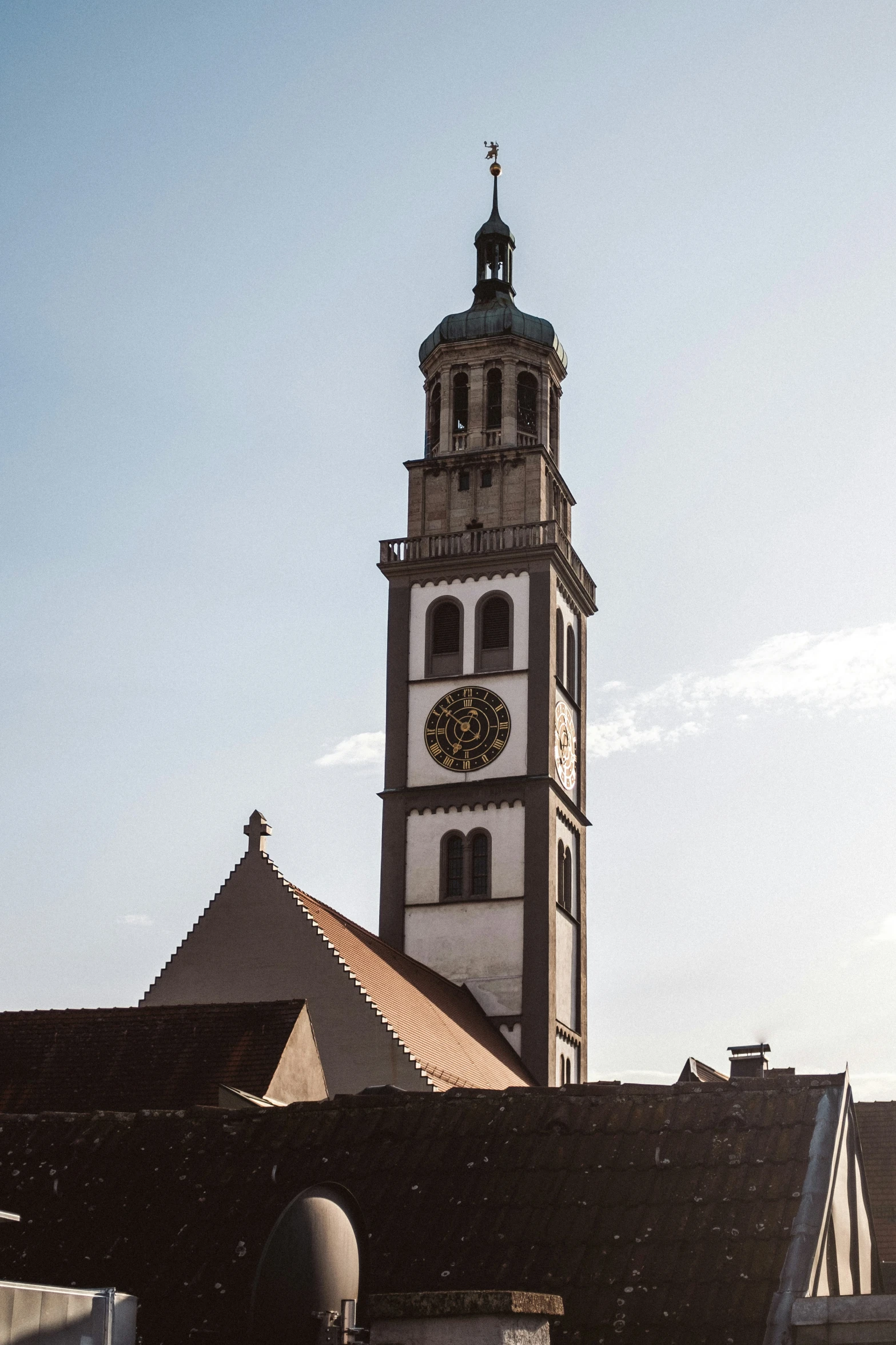 this clock tower is standing high in the sky