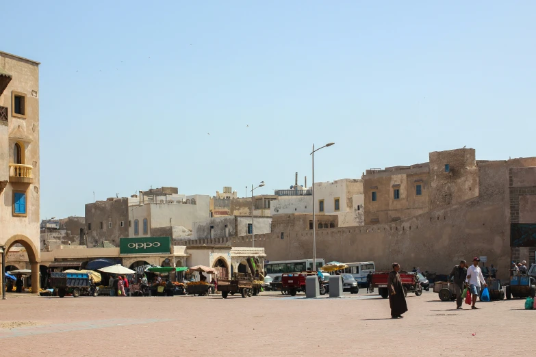 several people walking down the street in an old city