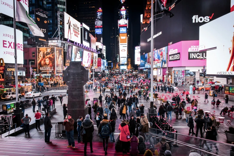 people are walking on the sidewalk in the city