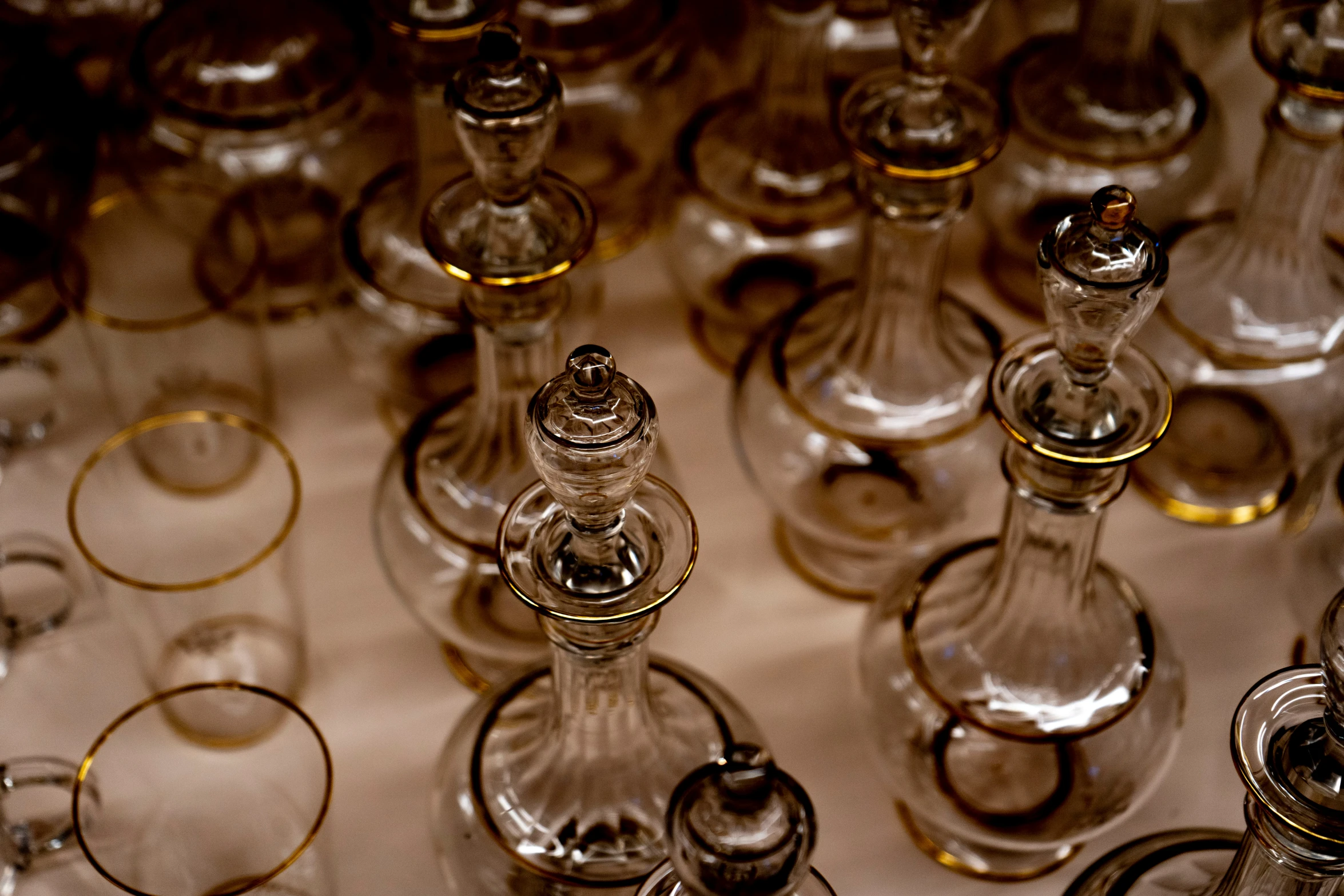 many small glasses sitting side by side on the table