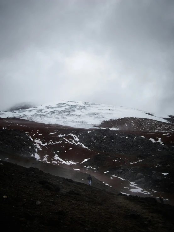 a small mountain has snow on it