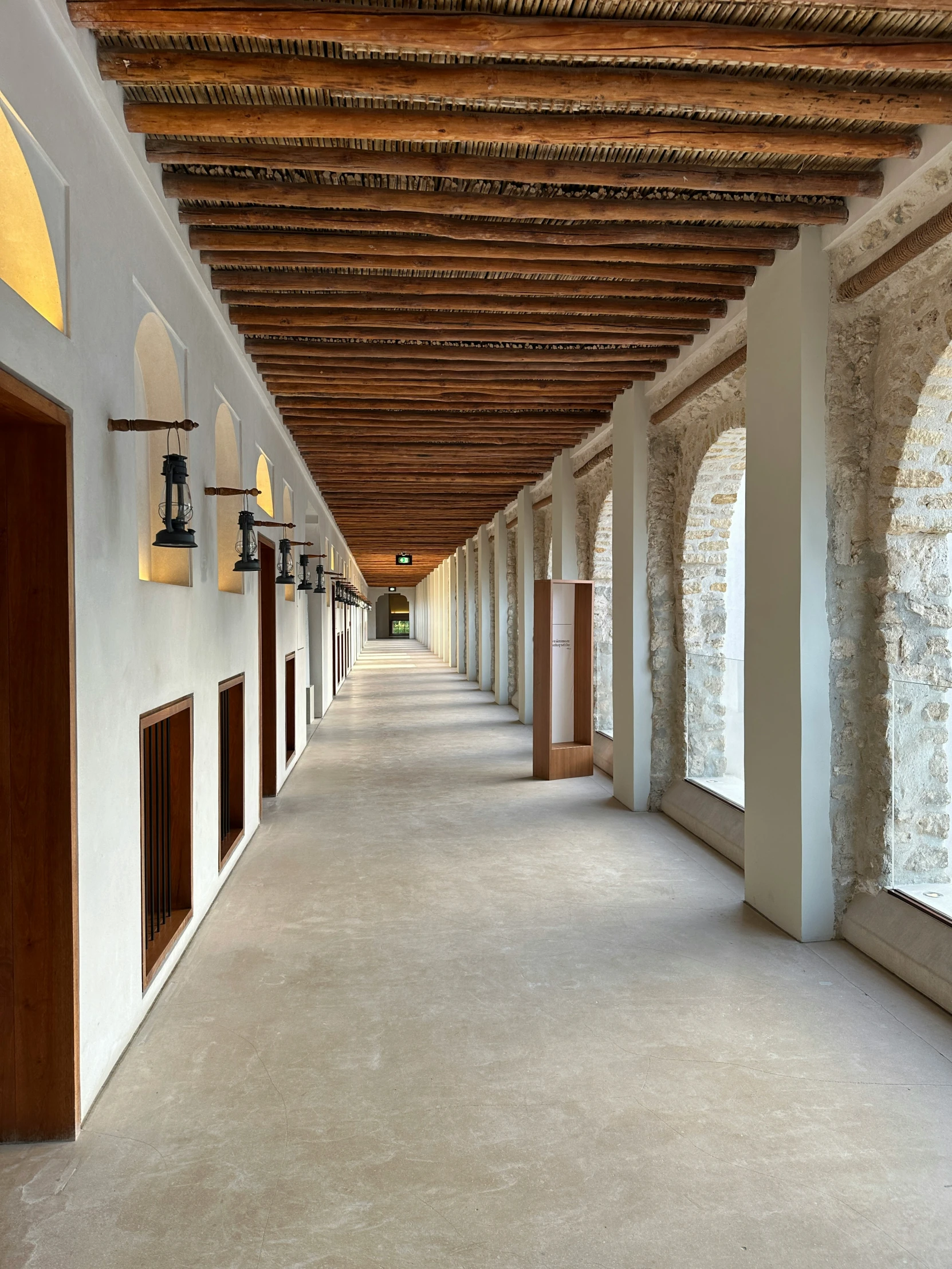 a view of a long building with wooden beams