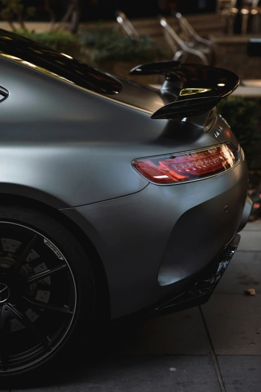 a close up of the tail of a gray car