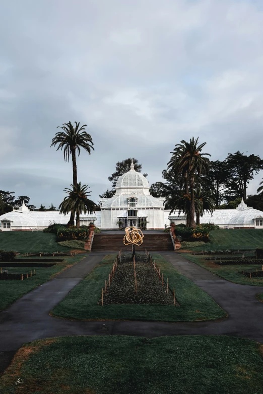 a path through a grassy park near an outdoor venue