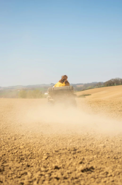 people riding in a vehicle in a wheat field