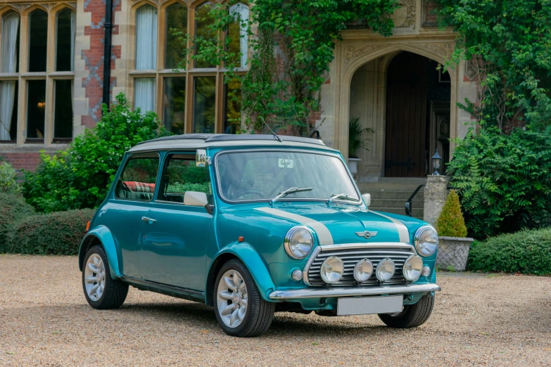 the small automobile is parked in front of the brick building