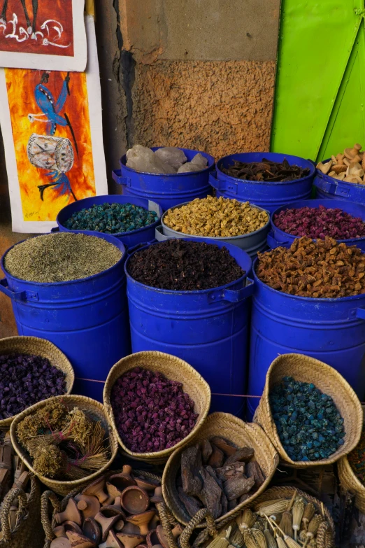 several buckets filled with various kinds of colorful seed