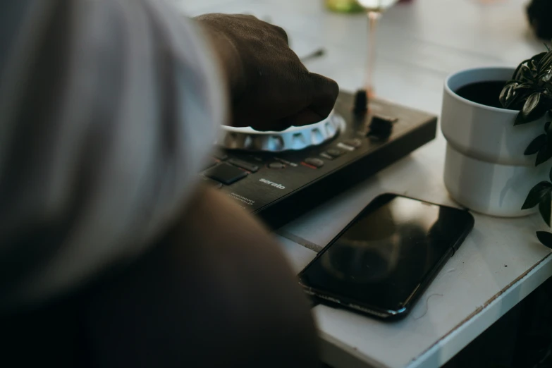 a man is typing on a small computer