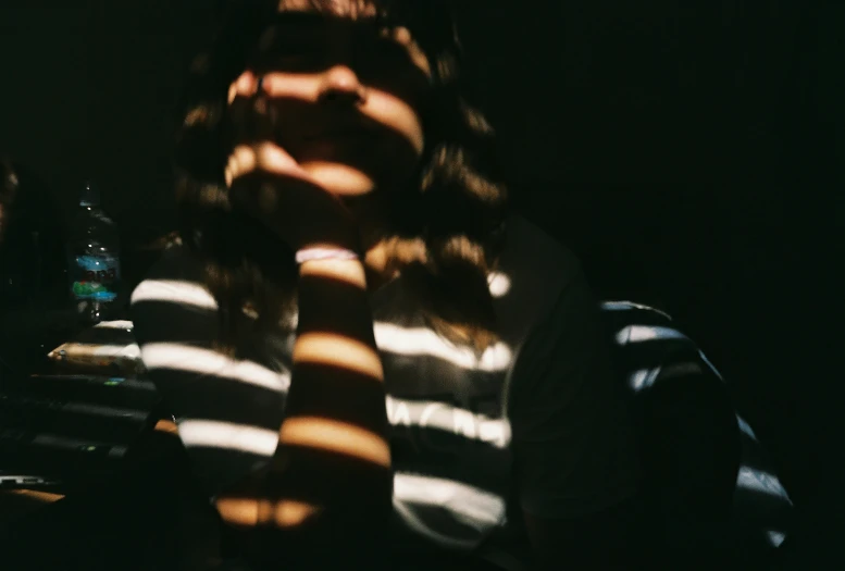 a woman making a shadow pose with her hands in front of her face