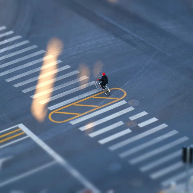 a person riding a bike on an intersection