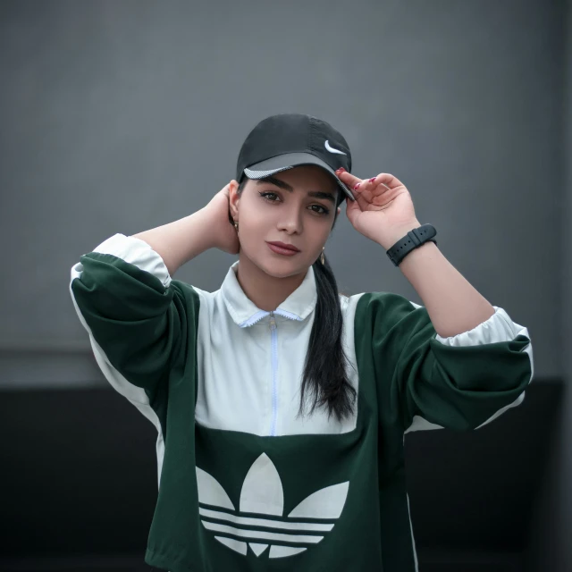 a girl posing in a green adidas shirt