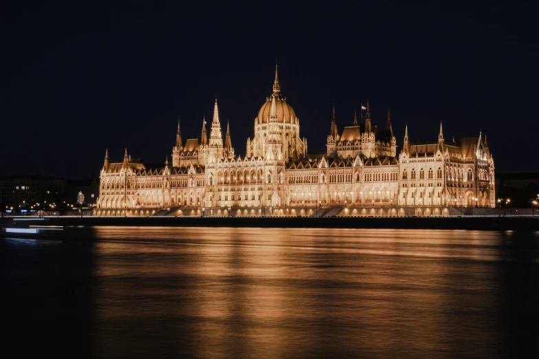 large palace lit up with lights on the side