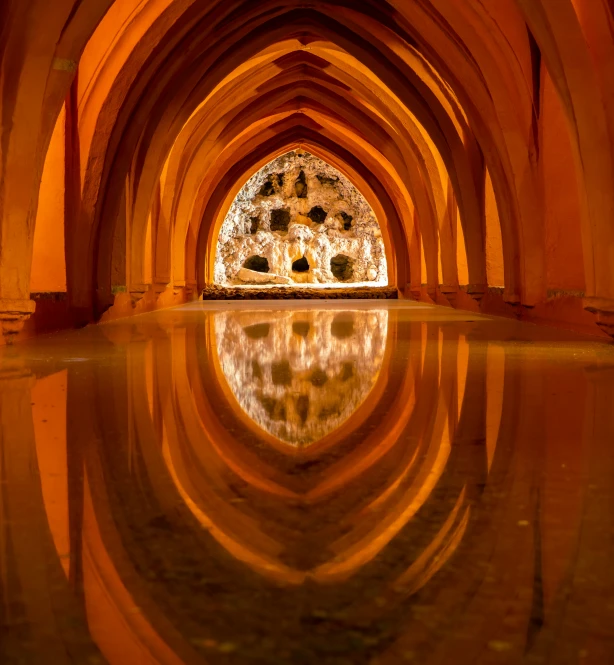 an interior of a palace looking down at a pool of water