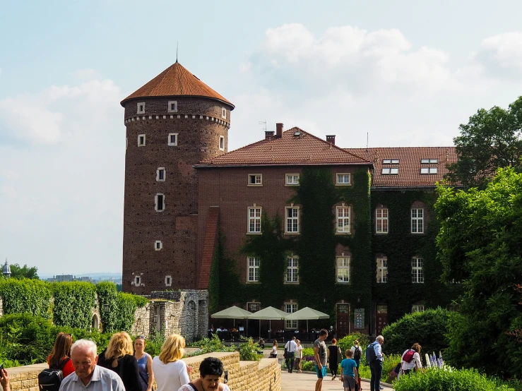 several people walking towards a castle like building