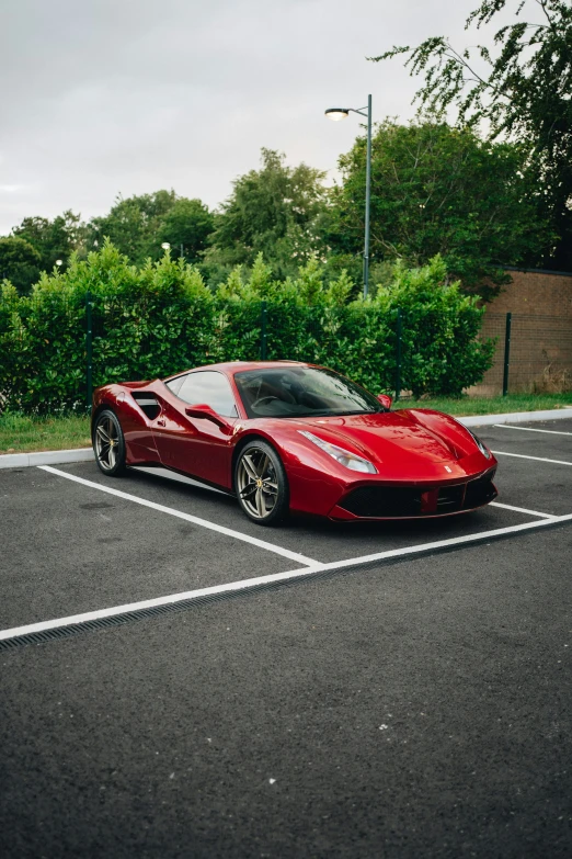 this is a red sports car parked in a parking lot