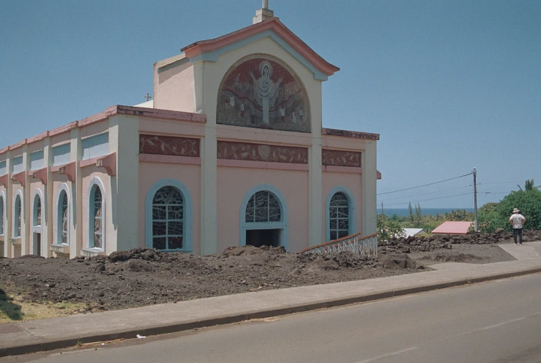 an old pink church with a large clock on it