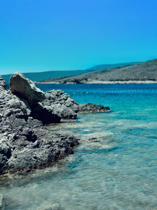 an open sea and rocks covered in water