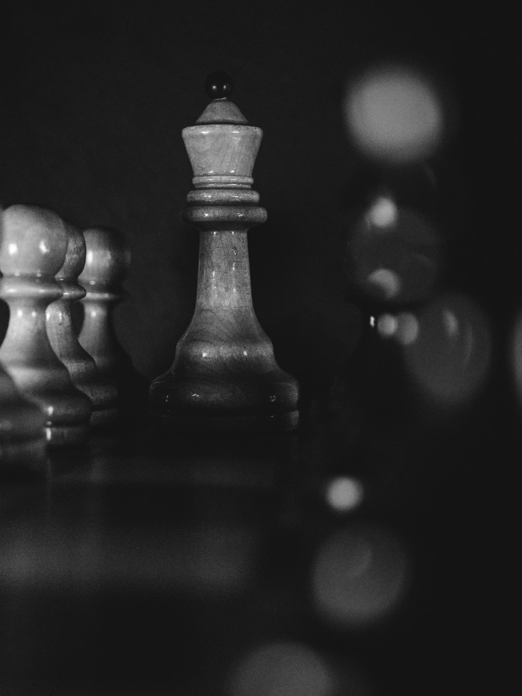 a chess piece and other pieces of chess on a black table