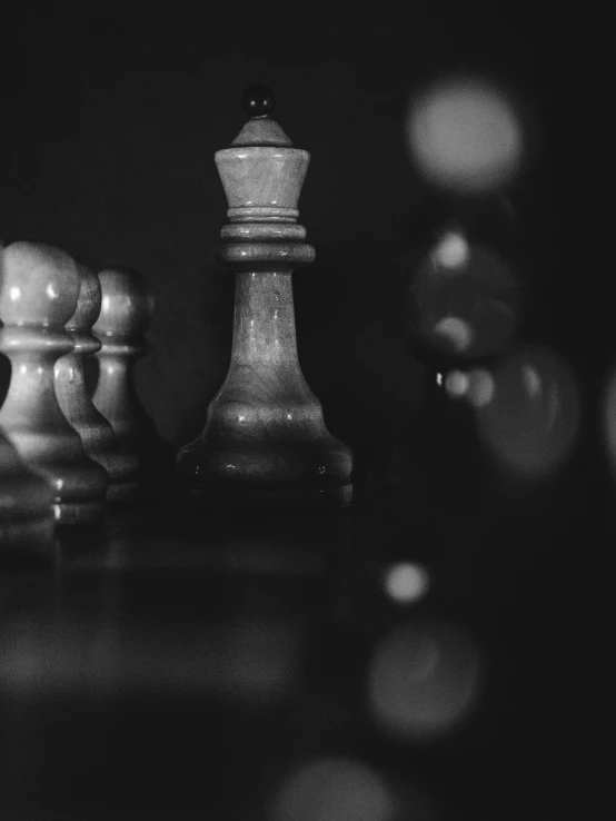 a chess piece and other pieces of chess on a black table