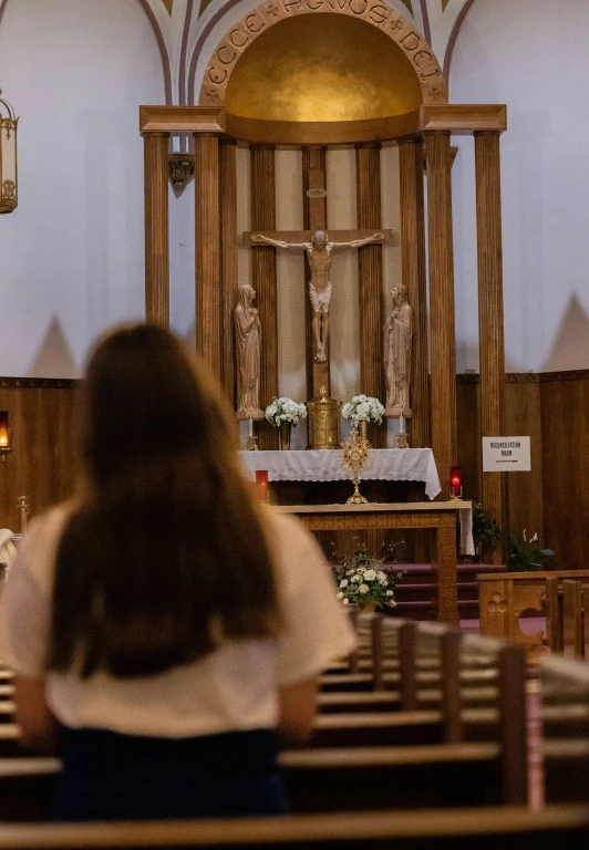 a woman standing in front of a chapel