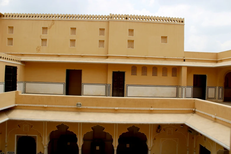 two people walking through the building's courtyard