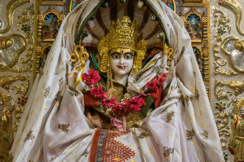 a statue in an ornate room with gold decorations