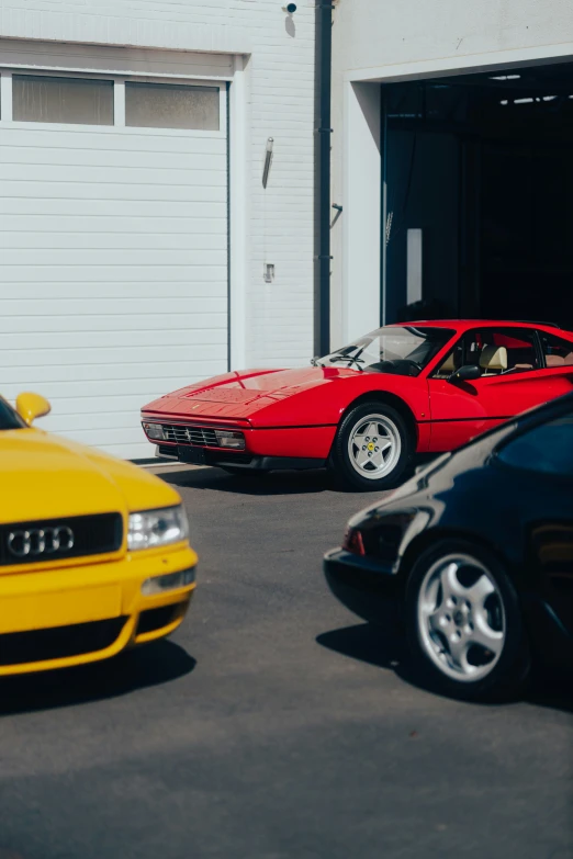 some yellow cars parked in front of a garage