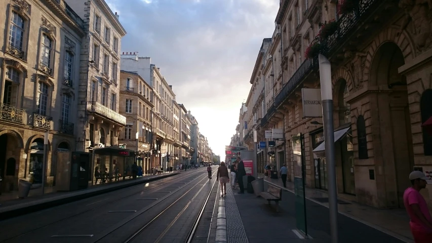 people walking on the sidewalk in a european city