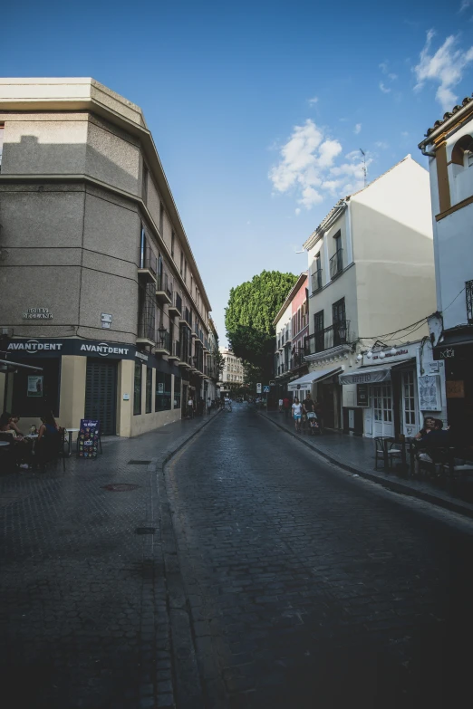 a street lined with several tall buildings and restaurants