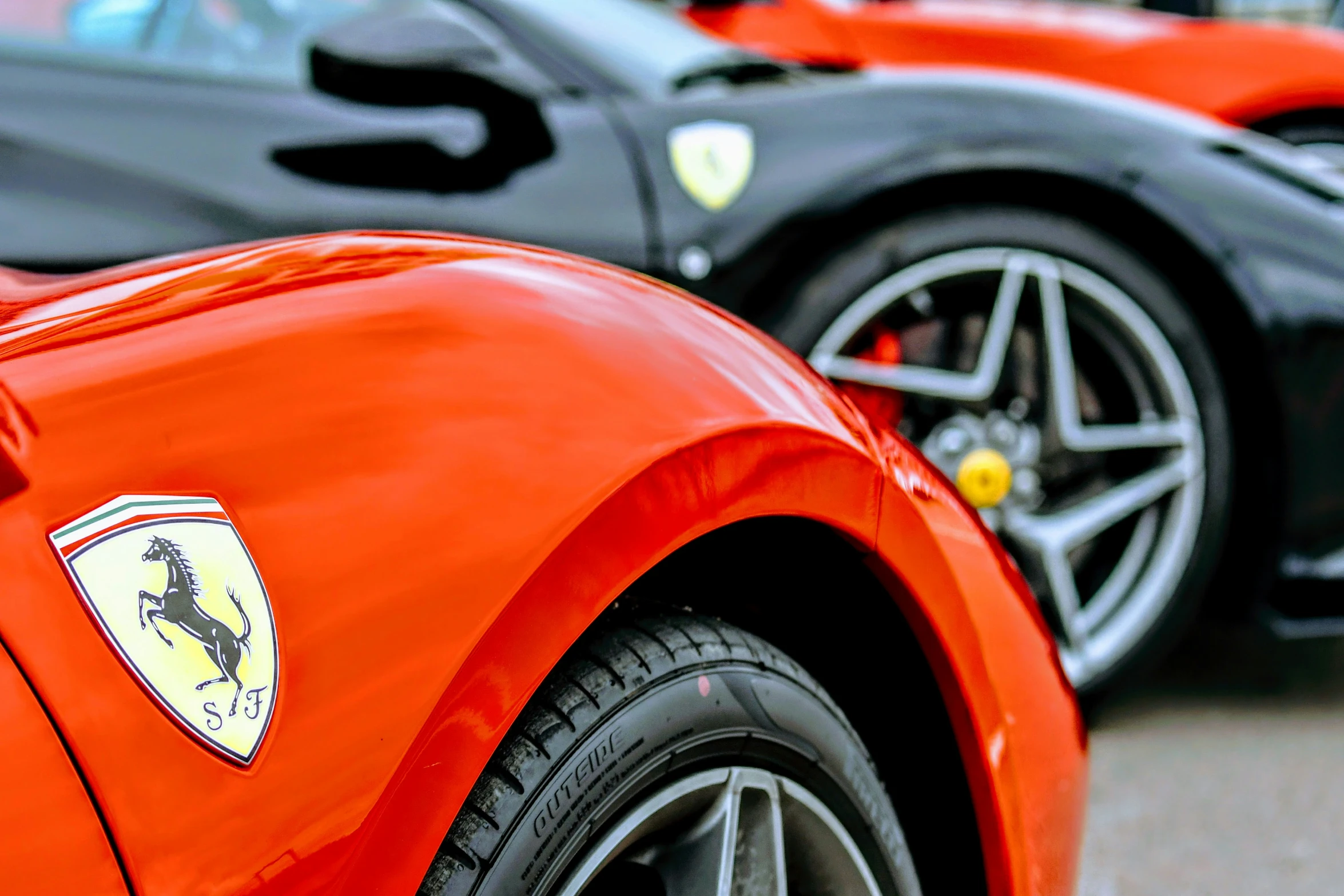 there are two red sports cars facing opposite directions