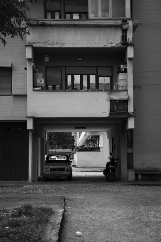 a motorcycle parked next to an apartment building