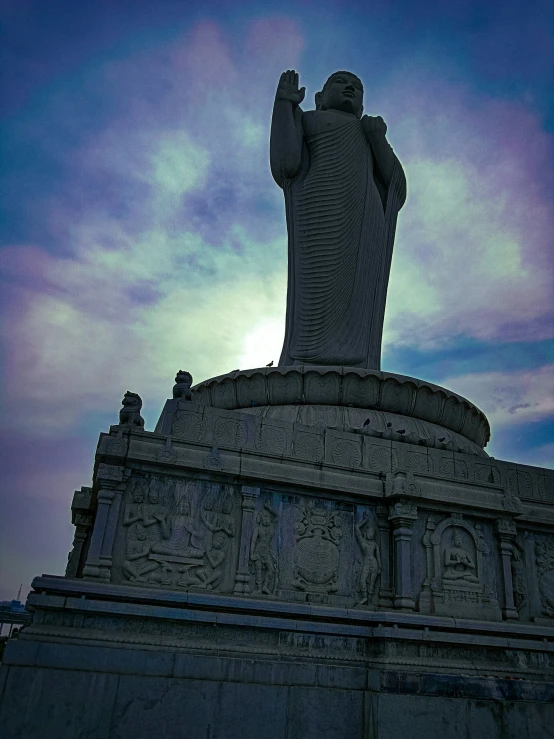 a statue with a big body in the evening